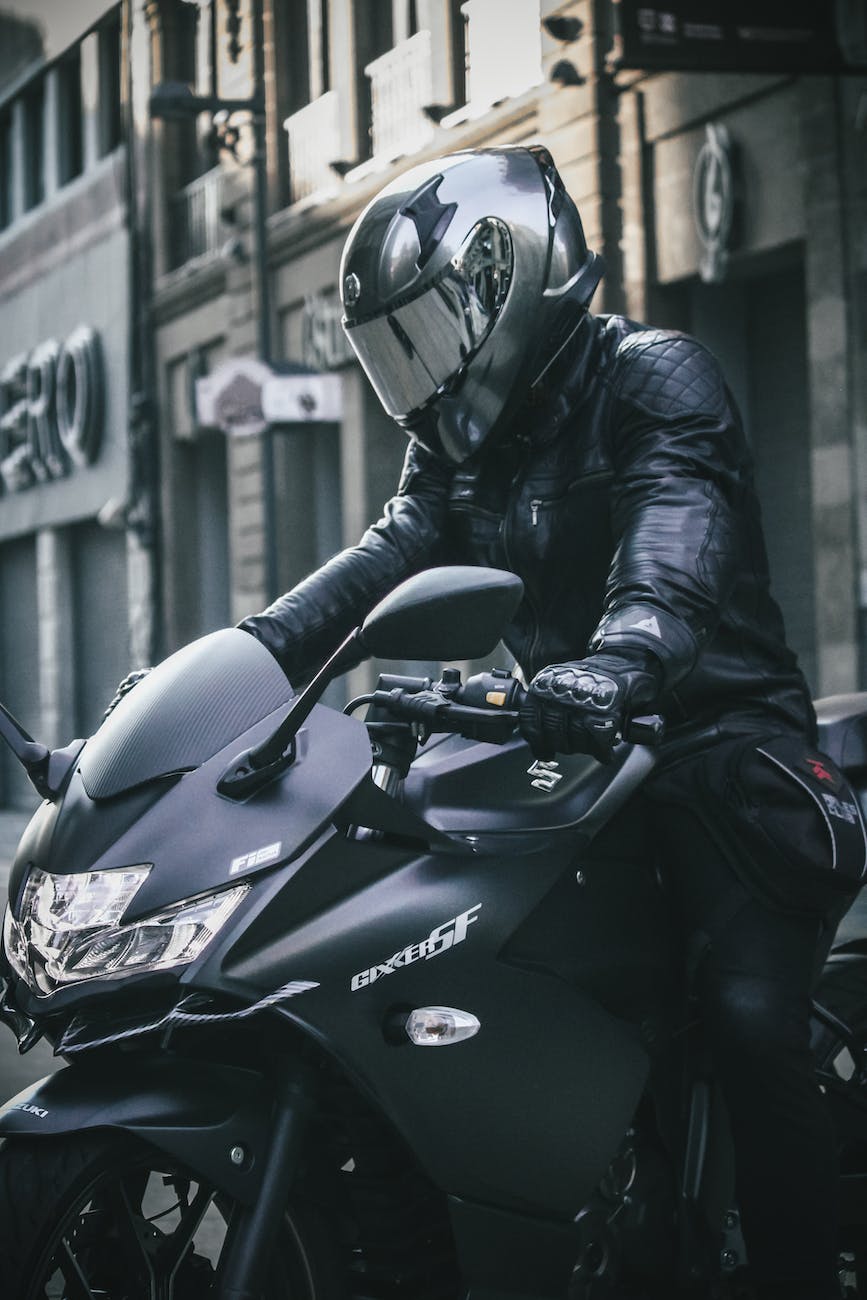 shot of a man on motorbike in a city