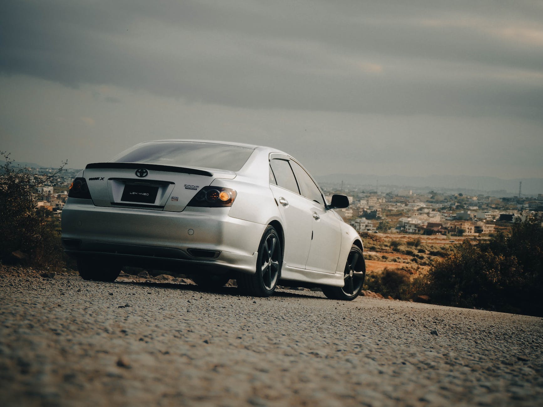 car on hill overlooking city